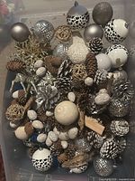 Top view of tote showing assorted baubles, pinecones, wicker balls, faux nuts, reindeer and gold branch