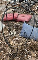 Full view of black metal hanging basket planter with coco liner and glass orb