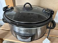 Front view showing Crock-Pot branding, digital panel and locking glass lid