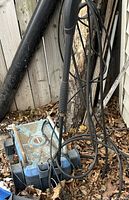 Base unit of blue/black electric pressure washer with hose and wand visible
