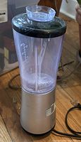 Front view of Hamilton Beach personal blender with silver base, clear jar and black lid