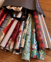 Canvas bag with multiple Christmas wrapping paper rolls