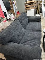 IKEA dark gray loveseat front angle showing cushions and arms