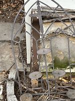 Full view showing Gothic arch frame, cross motif, and candle plates