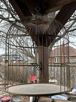 Full view of hanging gold wire bird cage with dome top and hook