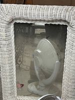 Front view showing full rectangular mirror with white wicker frame