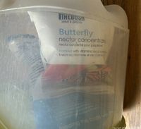 Front view of translucent feeder showing Linebush nectar concentrate packet inside