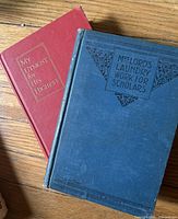 Red and blue cloth hardcovers titled My Utmost for His Highest and Mrs. Lord's Laundry Work for Scholars