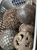overview of five decorative spheres in basket