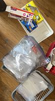 Overview showing boxed forks, zipper bag of spoons, storage bag boxes, trays