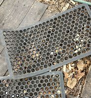 Top view of both black rubber mats showing honeycomb pattern and wear