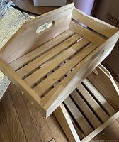 Top view of stacked wooden crates showing slatted bases and natural finish