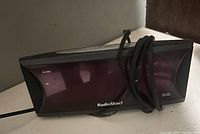 Front view of RadioShack clock radio showing tinted display and speaker grills