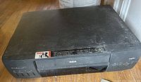 Front angled view of RCA VCR showing AccuSearch label, VHS slot, front controls, and overall wear
