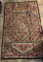 Full view of entire tapestry laid flat showing overall design and size