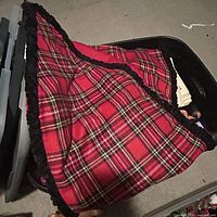 Overview of red plaid tartan table runner with fringe