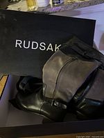 Boots inside original Rudsak box showing brand name