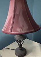 Full view of lamp showing burgundy fabric shade and metal lattice base