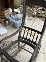 Front angled view of wooden spindle-back rocking chair frame