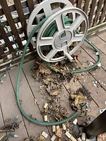 Overview of reel and hose on deck, leaves around base