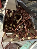 Wood bead strands in box showing brown and natural beads and header bar