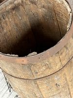 Top view of weathered wooden bucket showing interior and metal band