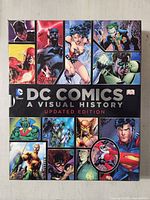 Front of slipcase showing title and collage of DC characters