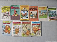 Front covers of ten vintage Heathcliff and Marmaduke paperback comic books