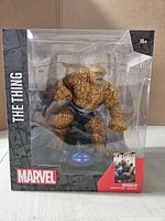Front view of boxed The Thing figure showing window, character and base