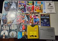All items laid out showing comics, manuals and reference books