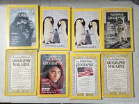 All eight National Geographic magazines laid out in two rows, covers facing up