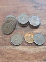 Stacks and spread of 18 copper-bronze coins showing reverse design and date range.