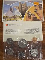 Front view of illustrated envelope and sealed coin set showing all components