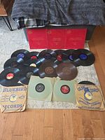All 21 records laid out showing red Continental sleeves, Bluebird sleeves, assorted labels