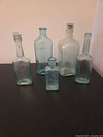 Group of five antique medicine bottles