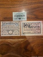 Three banknotes laid out: 10 Heller green, 50 Heller Traiskirchen, 50 Heller Gaflenz