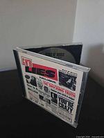 Front angle view showing CD partially open with disc and front insert