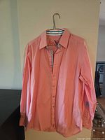 Full view of shirt on hanger showing color and style