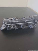 Left side view of Lionel 1664 locomotive showing cab number and running gear