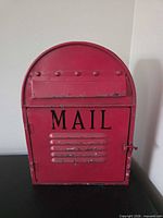 Front view of red mailbox with MAIL lettering