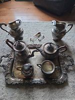 Group shot of entire seven-piece silver-plated set on tray