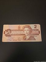 Full obverse of the $2 banknote showing denomination, portrait, and text