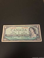 Obverse of 1954 $1 bill showing serial numbers, signatures, portrait