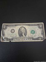 Full view of the front of the 1976 $2 bill showing serial number, district seal and wear