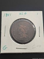 Obverse view in holder with date and grade visible