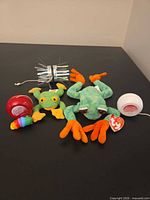 Group shot showing both frogs, three yo-yos, fidget grub