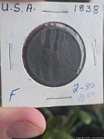 Obverse of 1838 large cent in holder showing Liberty head