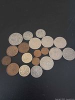 All 19 coins laid out on black background