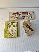 Three boxed games: Crib-Derby, The Wobbly Web, Quad