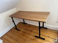 Full view of desk showing entire wood veneer top and metal frame